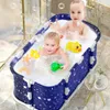 Two babies are playing in a portable bathtub filled with bubbles and toys. Produktbild-Vorschau