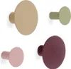Four wall hooks in different colors arranged in a grid. Produktbild-Vorschau
