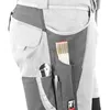 A close-up view of the side pocket of work pants, showing tools like a folding ruler and a utility knife. Produktbild-Vorschau