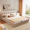 A modern bedroom with a beige upholstered bed, bedside table, and curtains. Produktbild-Vorschau