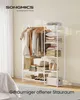 A white metal garment rack with clothes and accessories is shown in a room. Produktbild-Vorschau