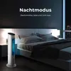 A bedroom scene at night, featuring a tower fan next to a bed. Produktbild-Vorschau