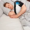 A man sleeping in bed wearing a shoulder brace with an ice pack. Anteprima dell’immagine prodotto