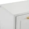 A close-up view of the top corner of a white cabinet with a gold handle visible on a drawer. Produktbild-Vorschau