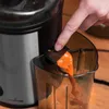 A person is using a juicer to extract juice into a container. Produktbild-Vorschau
