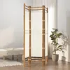 A room divider is shown in a bedroom setting next to a bed and a plant. Voir les images du produit