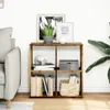 A wooden cube shelf unit with items on and in it, placed next to a sofa and a plant. Náhled obrázku produktu