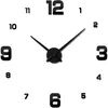 A wall clock with black numbers and hands on a white background. Podgląd zdjęcia produktu