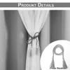 A close-up of a curtain tie-back with tassels, shown both on a curtain and as a separate item. Voir les images du produit