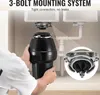 A person is installing a garbage disposal unit under a kitchen sink. Podgląd zdjęcia produktu