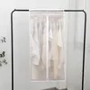 A transparent garment bag filled with white clothes hanging on a rack. Náhľad obrázku produktu