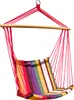 A colorful striped hanging chair suspended by red ropes from a wooden bar. Náhled obrázku produktu