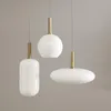 Three modern pendant lights with white glass shades and gold accents against a plain gray background. Náhľad obrázku produktu