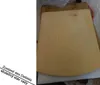 A beige pizza oven lid with the brand name embossed on it, placed on a cardboard box. Produktbild-Vorschau