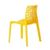 A yellow plastic chair with a web-like pattern on the backrest, shown from a side angle against a white background. Produktbild-Vorschau