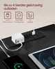 A close-up view of a black power strip with multiple outlets and USB ports, charging a white adapter, a smartphone, and a tablet. Produktbild-Vorschau