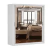 A white sliding door wardrobe with mirrored doors, reflecting a bedroom interior. Náhľad obrázku produktu