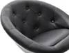 A close-up view of the interior of a black tufted chair. Náhled obrázku produktu