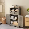 A bathroom cabinet filled with toiletries and towels, next to a shower stall and a vanity. Produktbild-Vorschau