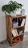 A wooden crate shelf unit with various items on display. Náhled obrázku produktu