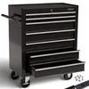 A black AREBOS tool chest with seven drawers, some of which are open, sits on a white background. Several ball bearings are scattered to the right of the tool chest. Náhled obrázku produktu