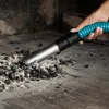 A hand is using a vacuum cleaner to clean ash and debris from a fireplace. Anteprima dell’immagine prodotto