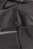 A close-up view of a black sports bag, showing zippers and a mesh pocket. Náhľad obrázku produktu