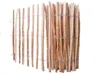 A close-up view of a wooden fence made of hazel wood stakes bound together with wire. Produktbild-Vorschau