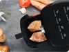 An air fryer with seasoned chicken breasts inside, surrounded by ingredients like tomatoes and carrots. Anteprima dell’immagine prodotto