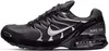 A side view of a black Nike Air Max Torch 4 sneaker against a white background. Voir les images du produit