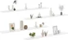 Four white shelves are displayed horizontally, each with various decorative items placed on them. Náhľad obrázku produktu