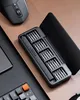 A black electric screwdriver set with multiple bits is laid out on a wooden desk next to a computer mouse and keyboard. Náhled obrázku produktu