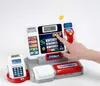 A child's toy cash register with a credit card reader and a hand pressing a button. Produktbild-Vorschau