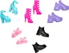 A collection of doll shoes arranged on a white background. Voir les images du produit