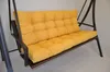 A yellow cushion on a brown swing chair frame. Produktbild-Vorschau