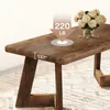 A close-up shot of a rustic wooden coffee table with a vase of flowers on top, highlighting its thickness and weight capacity. Podgląd zdjęcia produktu