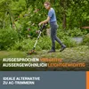 A woman is using a cordless grass trimmer in a garden with flowers and greenery. Produktbild-Vorschau