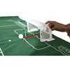 A miniature soccer game with players and a goal on a green field. Produktbild-Vorschau