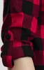 Close-up of a red and black checkered flannel shirt sleeve with the cuff rolled up. Náhled obrázku produktu