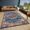A living room with a sofa, rug, and a large window overlooking a garden. Anteprima dell’immagine prodotto