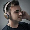 A man wearing headphones and listening to music. Anteprima dell’immagine prodotto