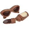 Two chocolate confectionery items shaped like sunglasses and lipstick against a white background. Produktbild-Vorschau