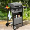 A Royal Gourmet gas grill is set up on a wooden deck outdoors, with greenery in the background. It is equipped with grilling tools and condiments. Produktbild-Vorschau