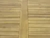 A close-up view of a wooden table surface, showing the grain and texture of the wood. Produktbild-Vorschau