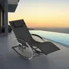 A black rocking lounge chair is placed on a patio next to an infinity pool at sunset. Voir les images du produit