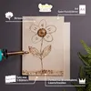 A piece of birch plywood with a flower design burned onto it, next to a wood-burning tool. Náhled obrázku produktu