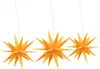Three yellow star-shaped Christmas lights hanging from thin wires against a white background. Voir les images du produit