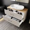 A modern bathroom vanity with a sink and drawers, featuring toiletries and towels. Produktbild-Vorschau