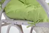 Close-up of a green cushion tied to a white rattan chair. Náhled obrázku produktu