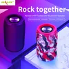 Two portable Bluetooth speakers are displayed on a geometric background with purple and pink lighting. Produktbild-Vorschau